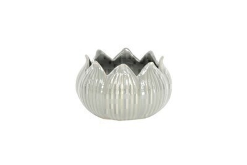 <p>Grey ceramic lotus flower tea light candle holder by the designer Gisela Graham who designs unique gifts for the home and garden. This t.light holder would make an ideal gift for someone special or as a treat for your own home. Fits standard size tea lights. Also available in Green. Size (LxWxD) 12.8x7.6x12.8cm</p>